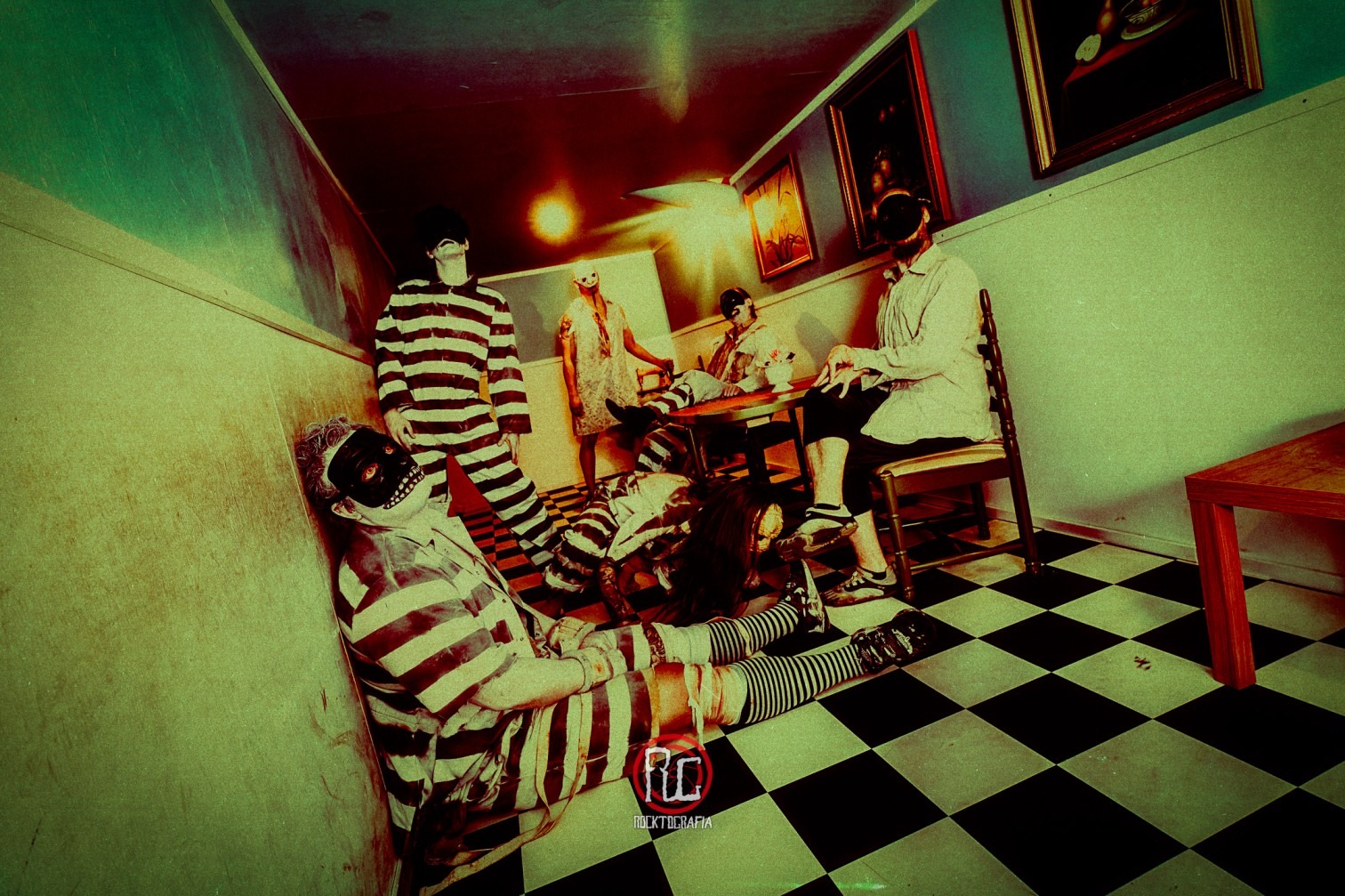 Agarwaen band members in their disturbing costumes, gathered in a room with a black and white checkered floor, creating a unsettling scene.